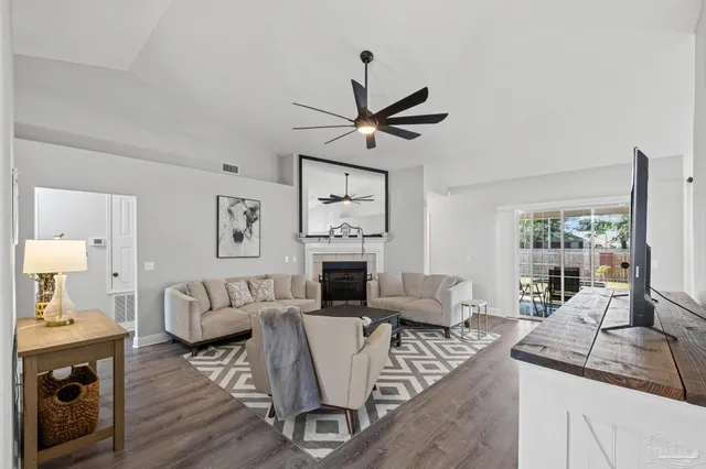 a living room with furniture and a fireplace