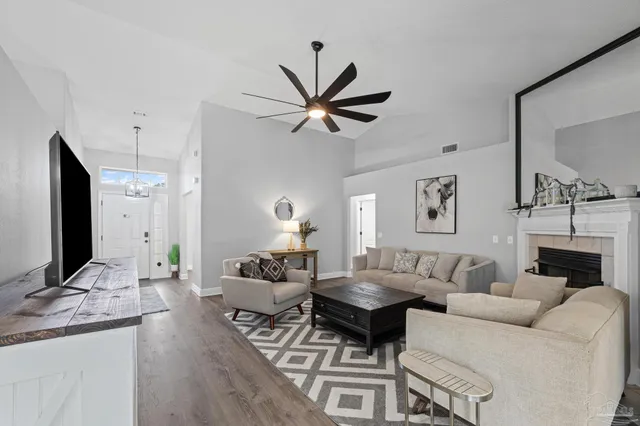 a living room with furniture and a wooden floor