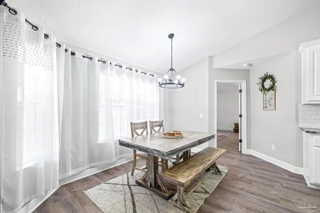 a kitchen with stainless steel appliances granite countertop a refrigerator sink and cabinets