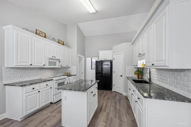a view of a storage & utility room with closet wooden floor