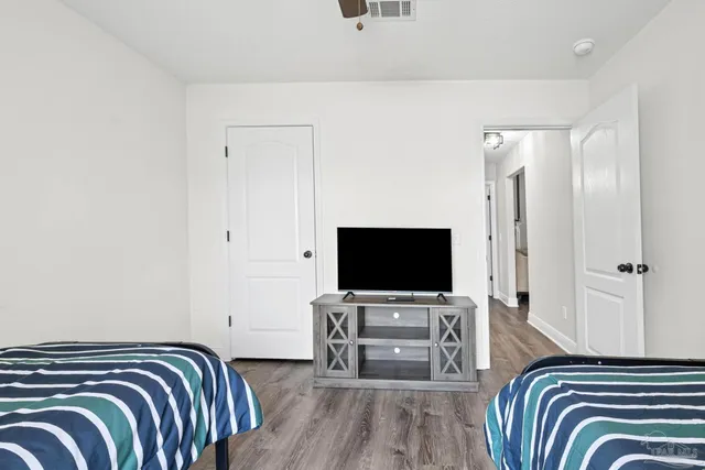 a view of a backyard with a small cabin and a large tree