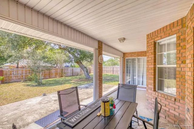 a view of a house with backyard porch and sitting area