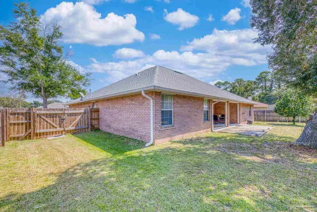 an aerial view of a house with garden space and a street view