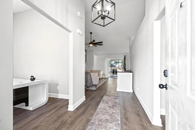 a view of a room with wooden floor lounge chair and windows
