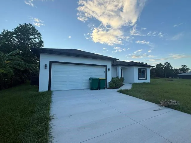 a view of a house with a yard and garage