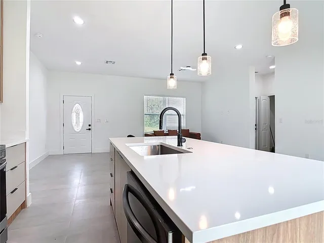 a kitchen with sink and chandelier