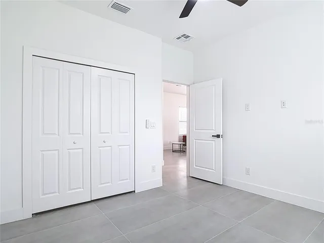 a view of a livingroom with a projector and ceiling fan
