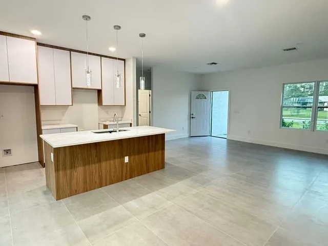 a spacious bathroom with a double vanity sink and a mirror