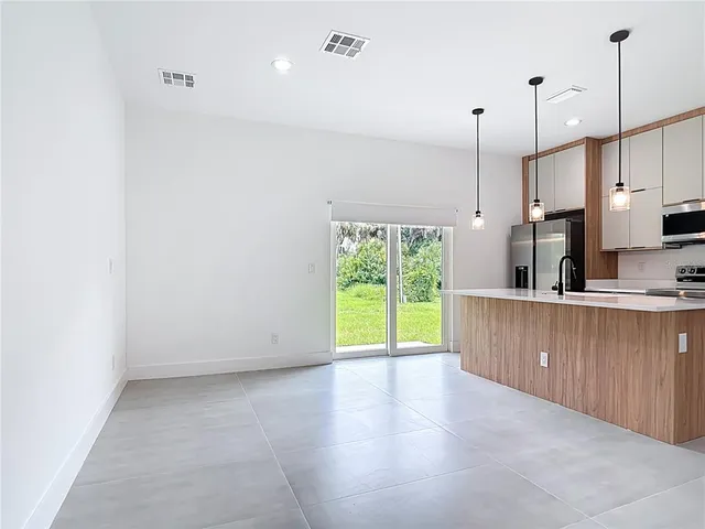 a view of a kitchen with a sink and a window