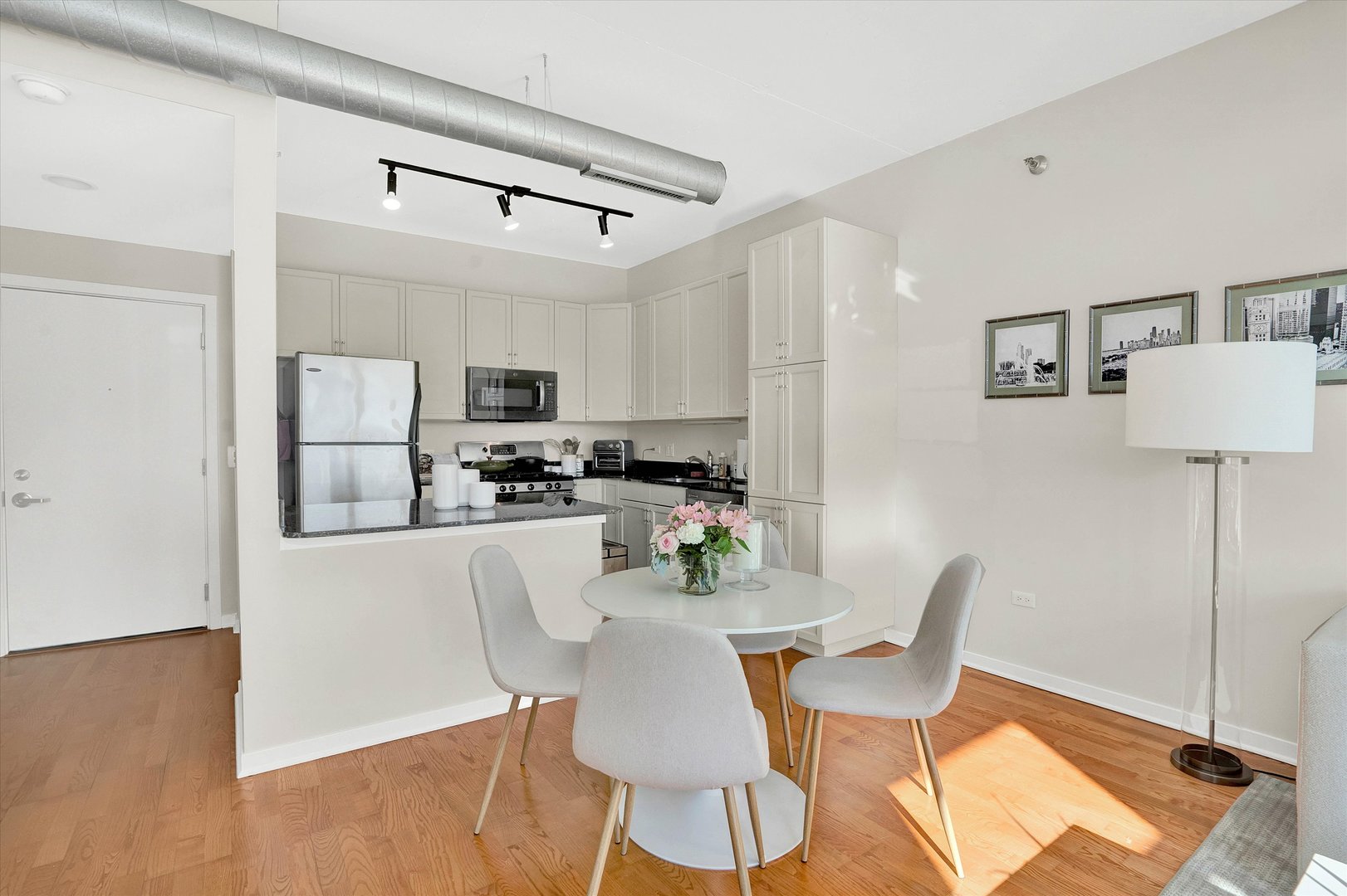 909 West Washington Boulevard, Unit 1002 Chicago, IL 60607 - Photo 2 of 15 a view of a dining room with furniture and wooden floor