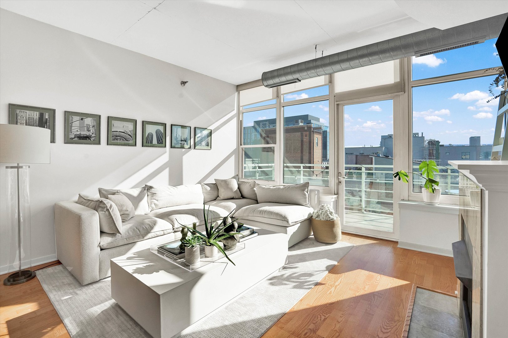 909 West Washington Boulevard, Unit 1002 Chicago, IL 60607 - Photo 7 of 15 a living room with furniture large windows and wooden floor
