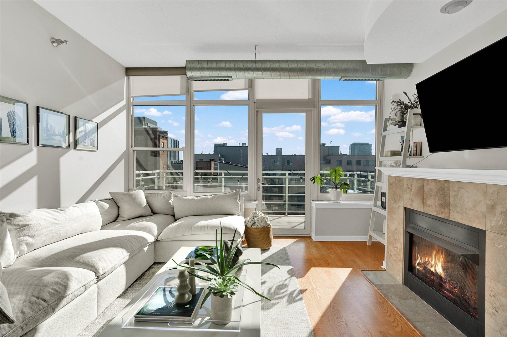 909 West Washington Boulevard, Unit 1002 Chicago, IL 60607 - Photo 8 of 15 a living room with furniture a fireplace and a flat screen tv