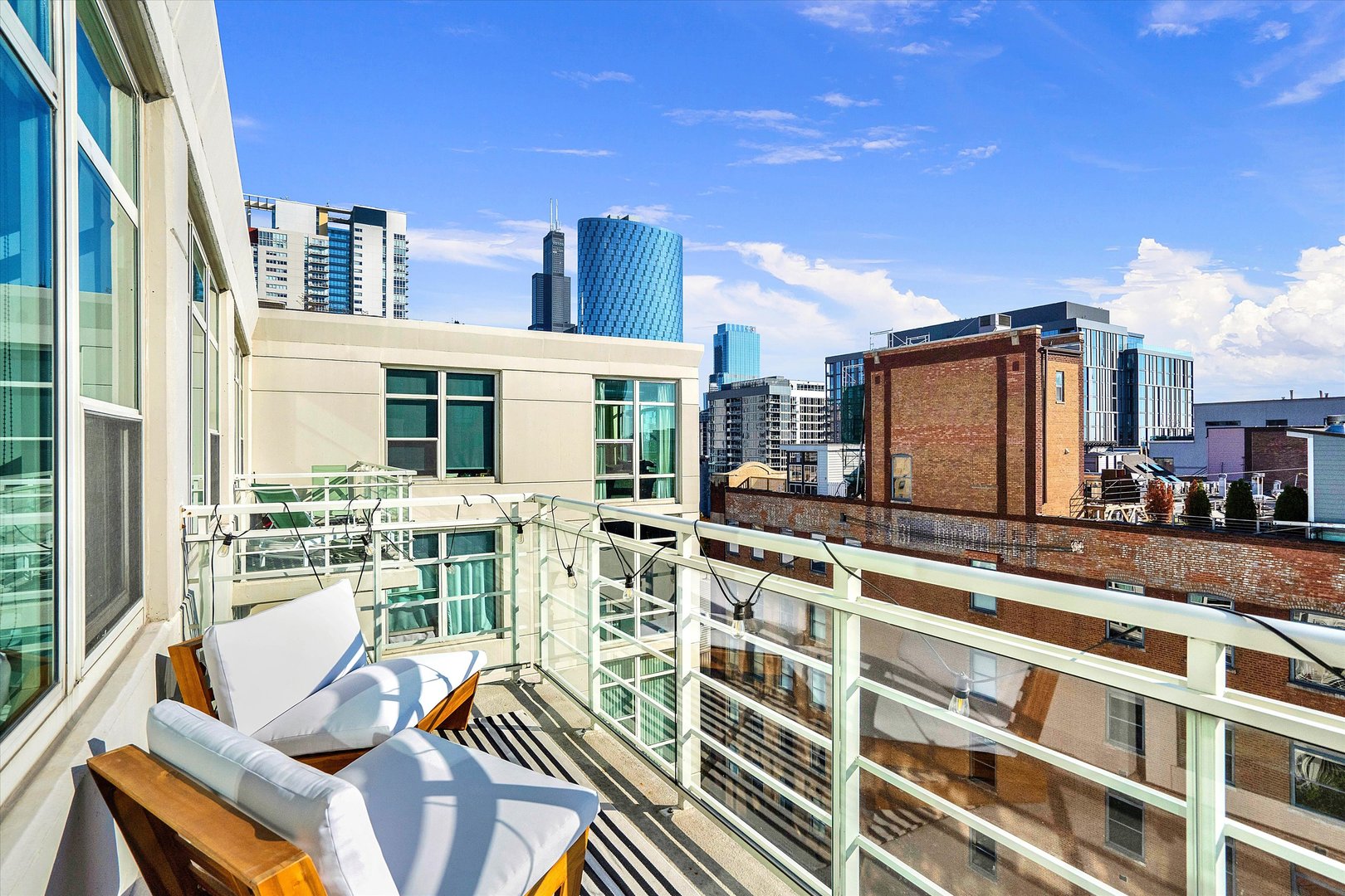 909 West Washington Boulevard, Unit 1002 Chicago, IL 60607 - Photo 9 of 15 a view of a balcony with chairs