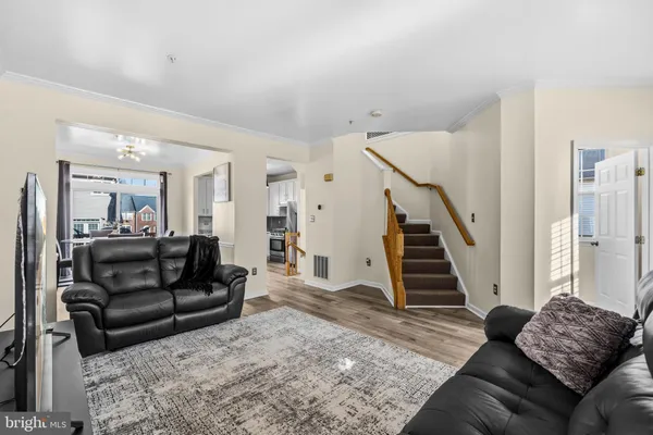 a kitchen with stainless steel appliances granite countertop a refrigerator a stove and a sink