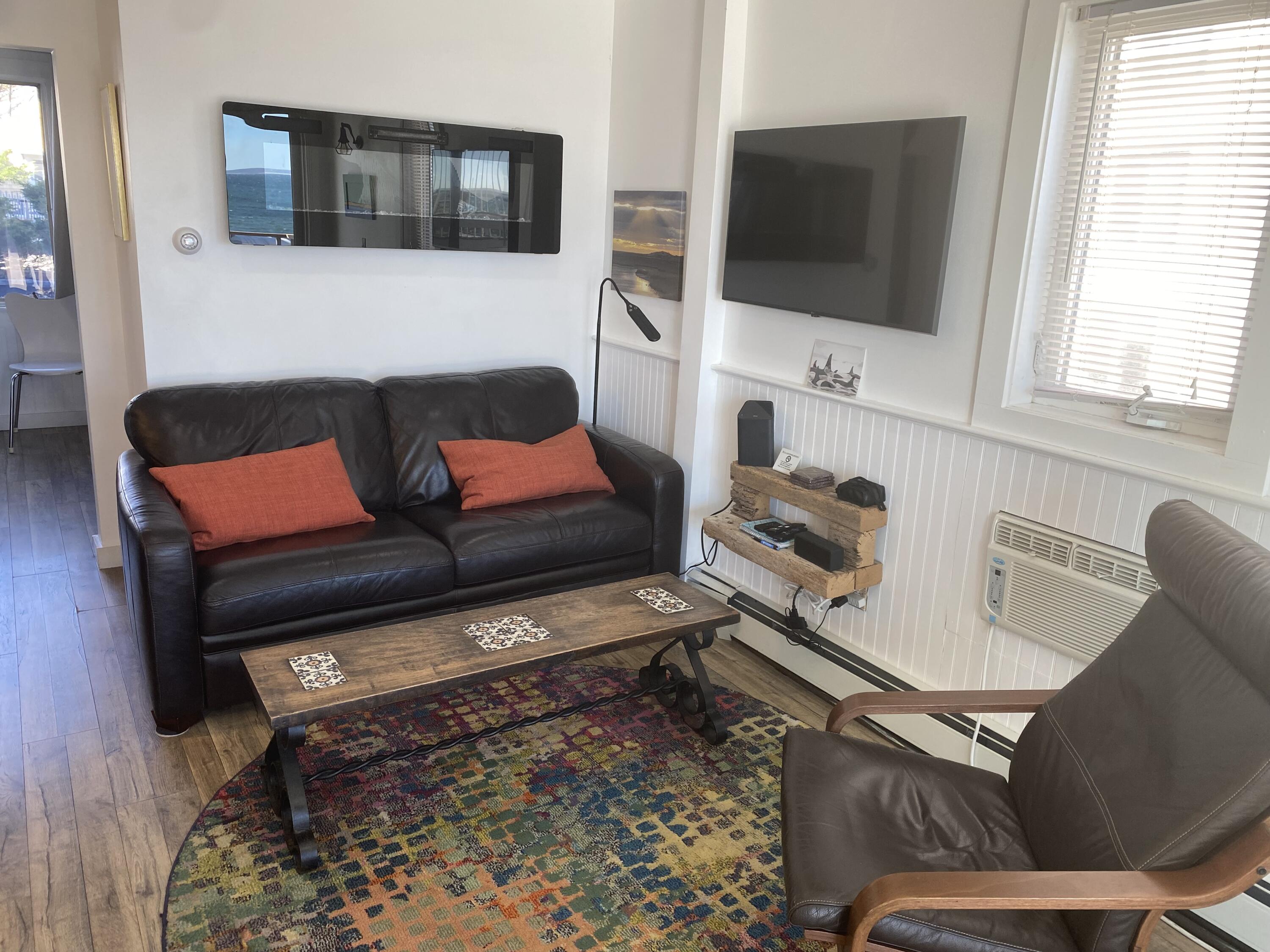 495 Commercial Street, Unit U11 Provincetown, MA 02657 - Photo 12 of 29 a living room with furniture and a flat screen tv