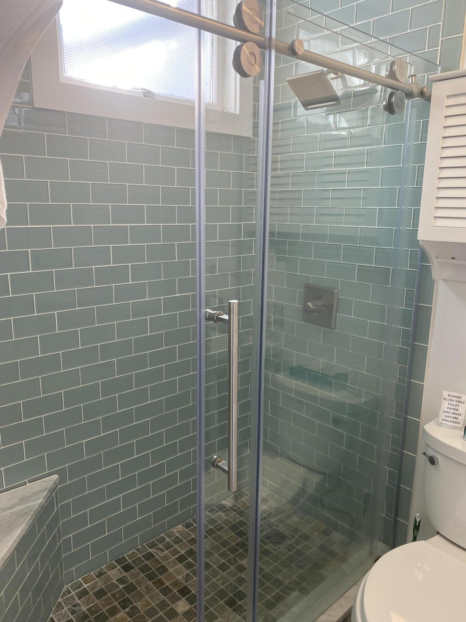 495 Commercial Street, Unit U11 Provincetown, MA 02657 - Photo 23 of 29 a bathroom with a shower and toilet