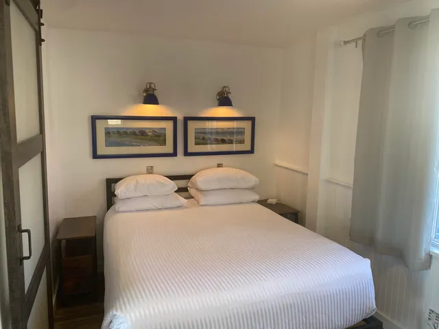 a view of a bedroom with furniture and lamp