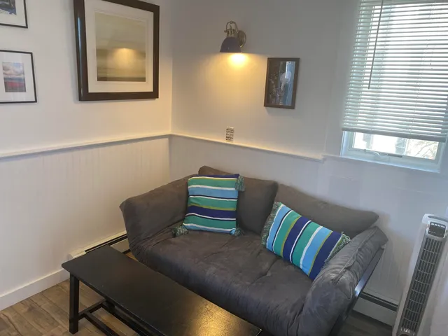 a view of a lake with lawn chairs