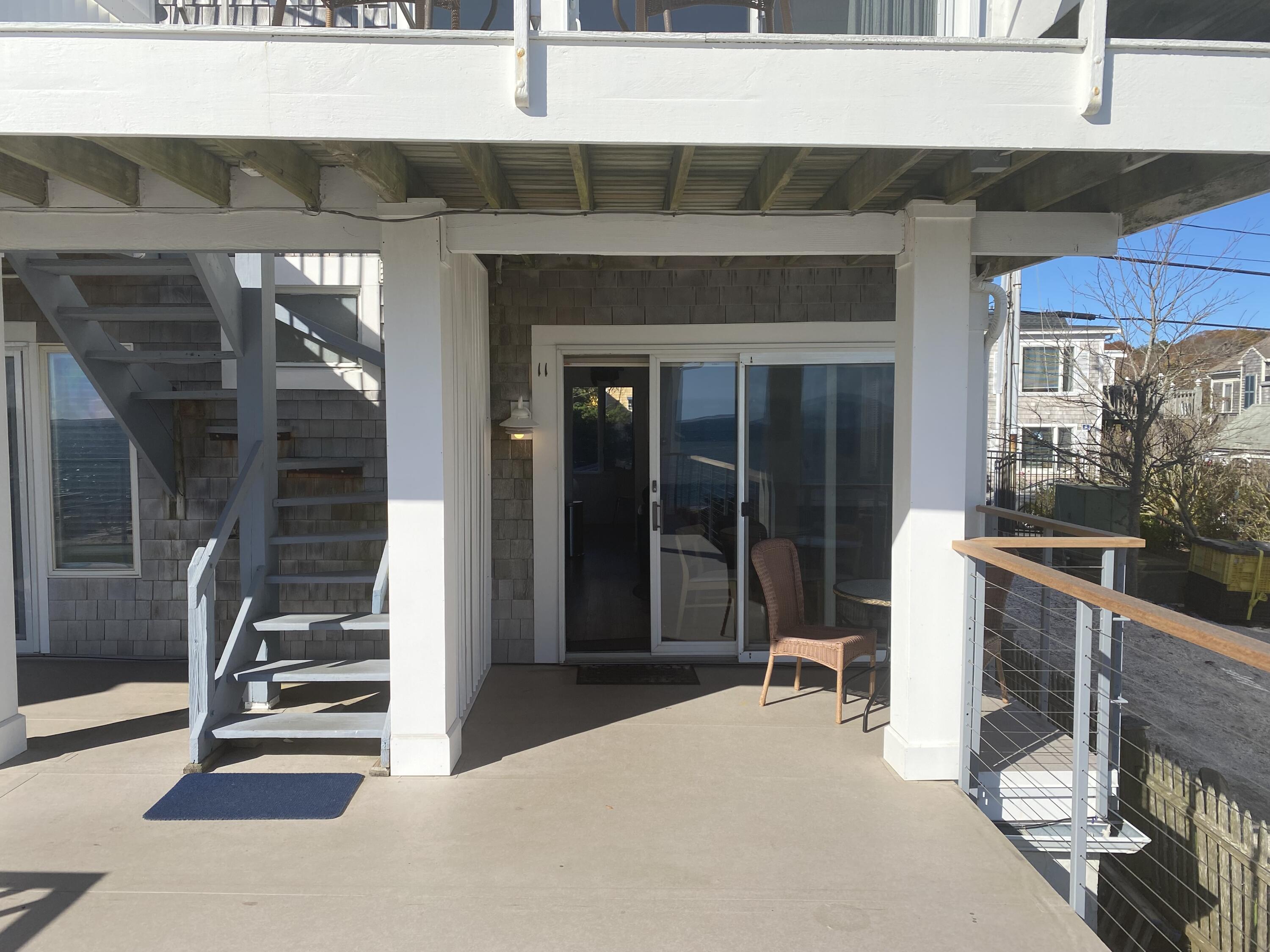 495 Commercial Street, Unit U11 Provincetown, MA 02657 - Photo 3 of 29 a room with lots of windows and a glass door