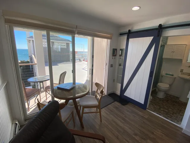 a living room with a table chairs and a large window