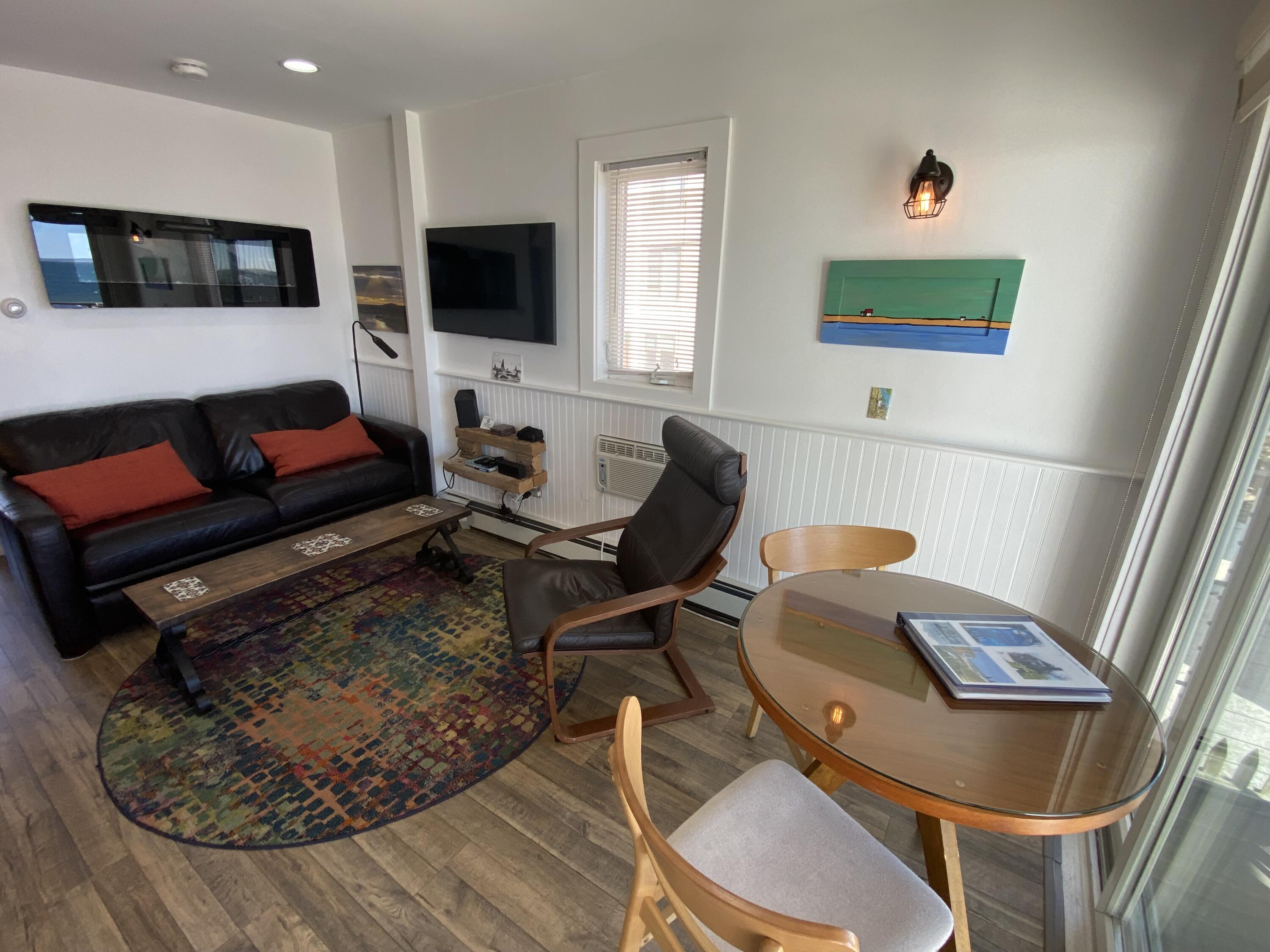 495 Commercial Street, Unit U11 Provincetown, MA 02657 - Photo 10 of 29 a living room with furniture and a flat screen tv
