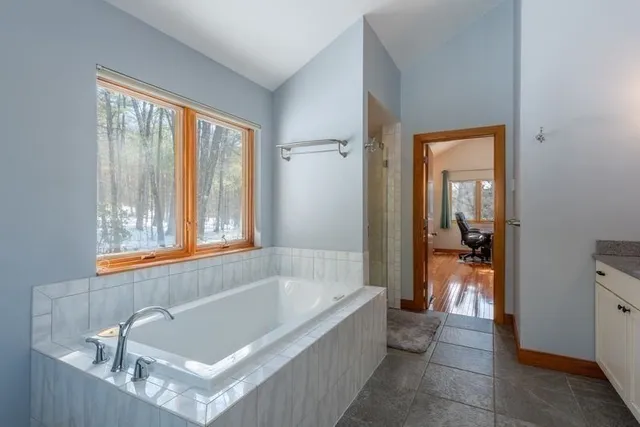 a bathroom with a tub sink and a window