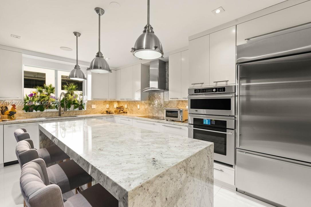 1000 Venetian Way, Unit 105 Miami, FL 33139 - Photo 20 of 49 a kitchen with stainless steel appliances granite countertop a sink counter space cabinets and stainless steel appliances