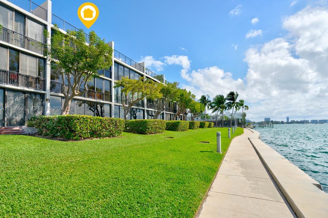 1000 Venetian Way, Unit 105 Miami, FL 33139 - Photo 2 of 49 a view of a house with a yard and potted plants