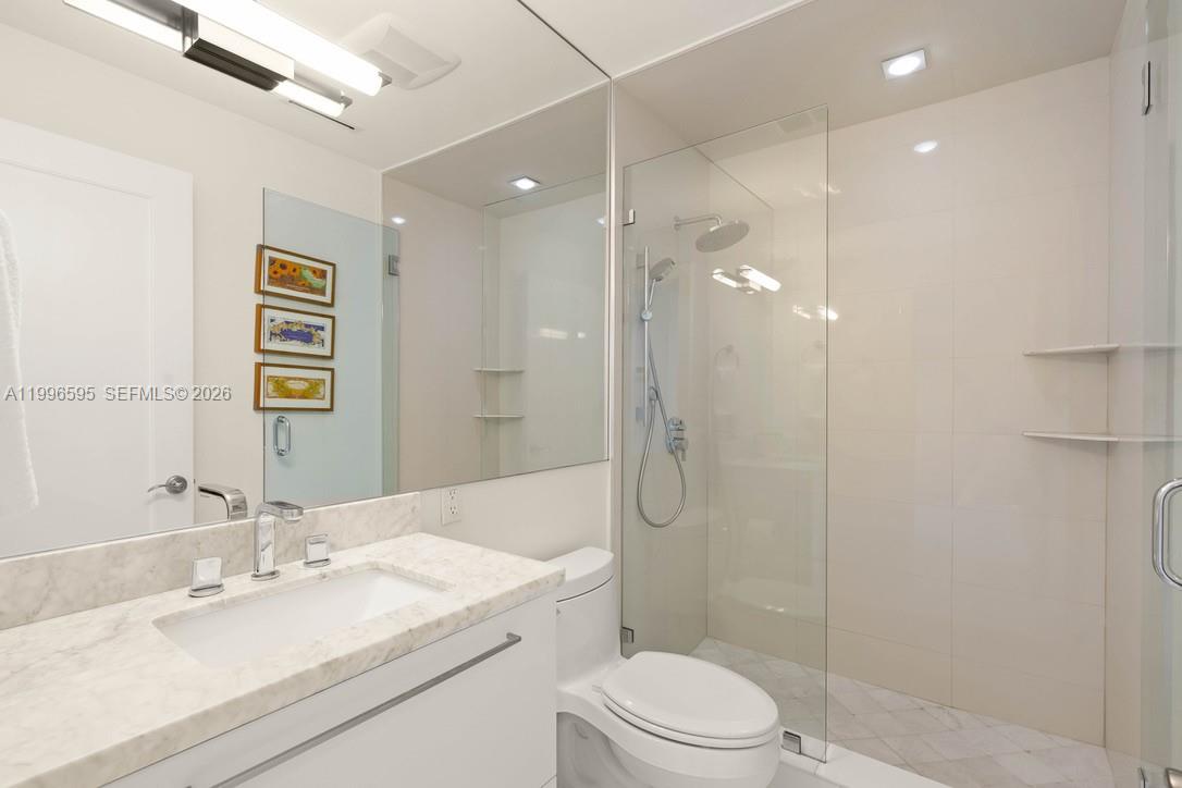 1000 Venetian Way, Unit 105 Miami, FL 33139 - Photo 22 of 49 a bathroom with a sink a toilet and shower