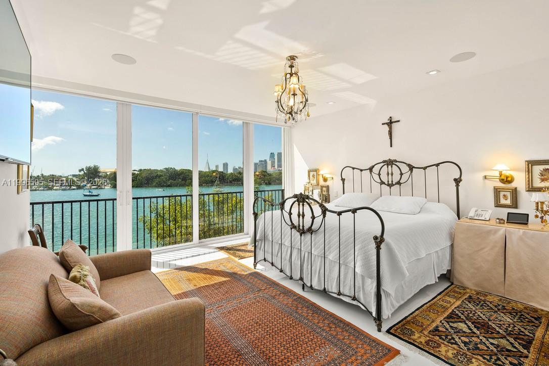 1000 Venetian Way, Unit 105 Miami, FL 33139 - Photo 27 of 49 a bedroom with furniture and a large window