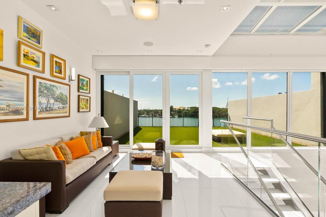 1000 Venetian Way, Unit 105 Miami, FL 33139 - Photo 33 of 49 a living room with furniture and floor to ceiling window