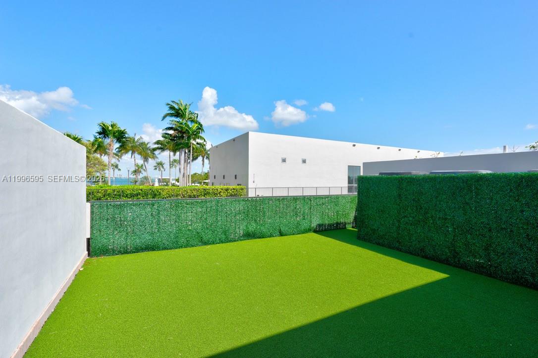 1000 Venetian Way, Unit 105 Miami, FL 33139 - Photo 38 of 49 a view of a big yard with potted plants and large tree