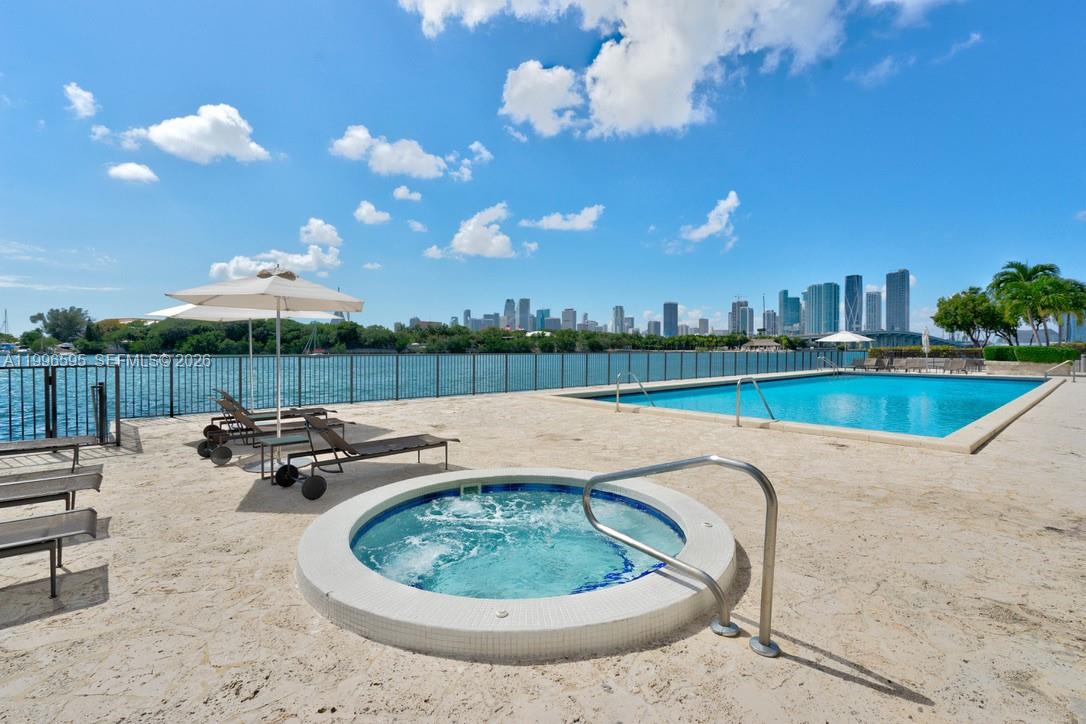1000 Venetian Way, Unit 105 Miami, FL 33139 - Photo 49 of 49 a view of a swimming pool with a patio and wooden floor