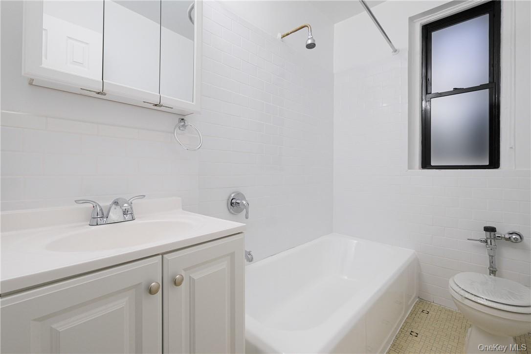 2685 Creston Avenue, Unit 1K Bronx, NY 10468 - Photo 5 of 7 a bathroom with a sink a toilet and tub