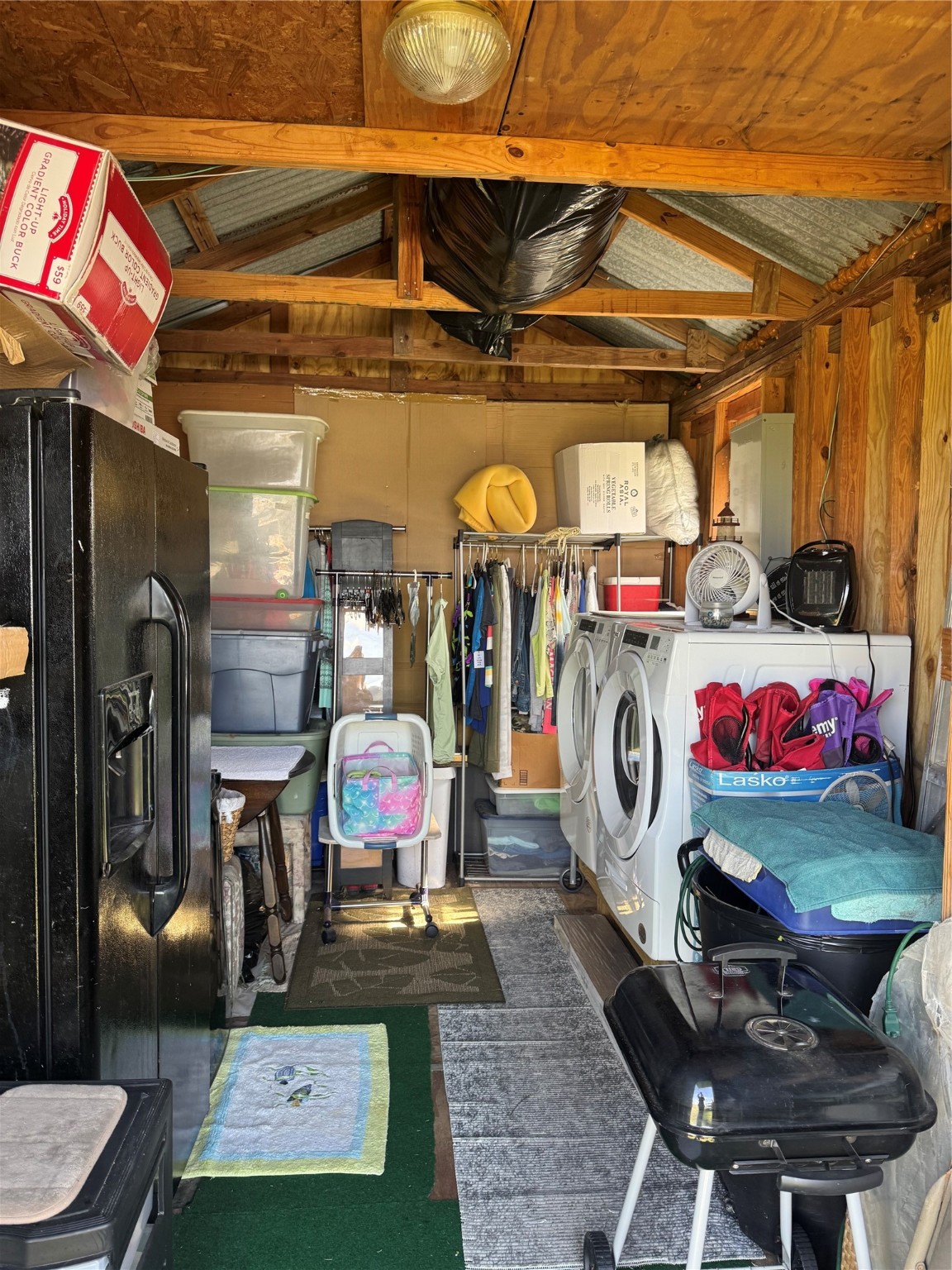 1561 County Road 299 Sargent, TX 77414 - Photo 25 of 26 a storage room with washer and dryer