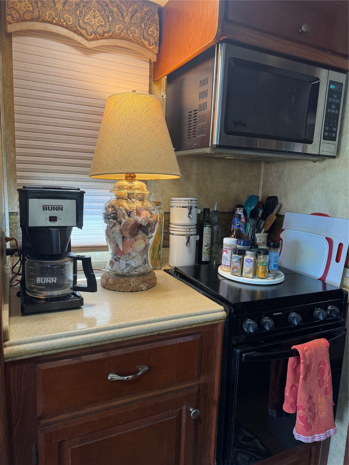 1561 County Road 299 Sargent, TX 77414 - Photo 8 of 26 a kitchen with a stove and a microwave