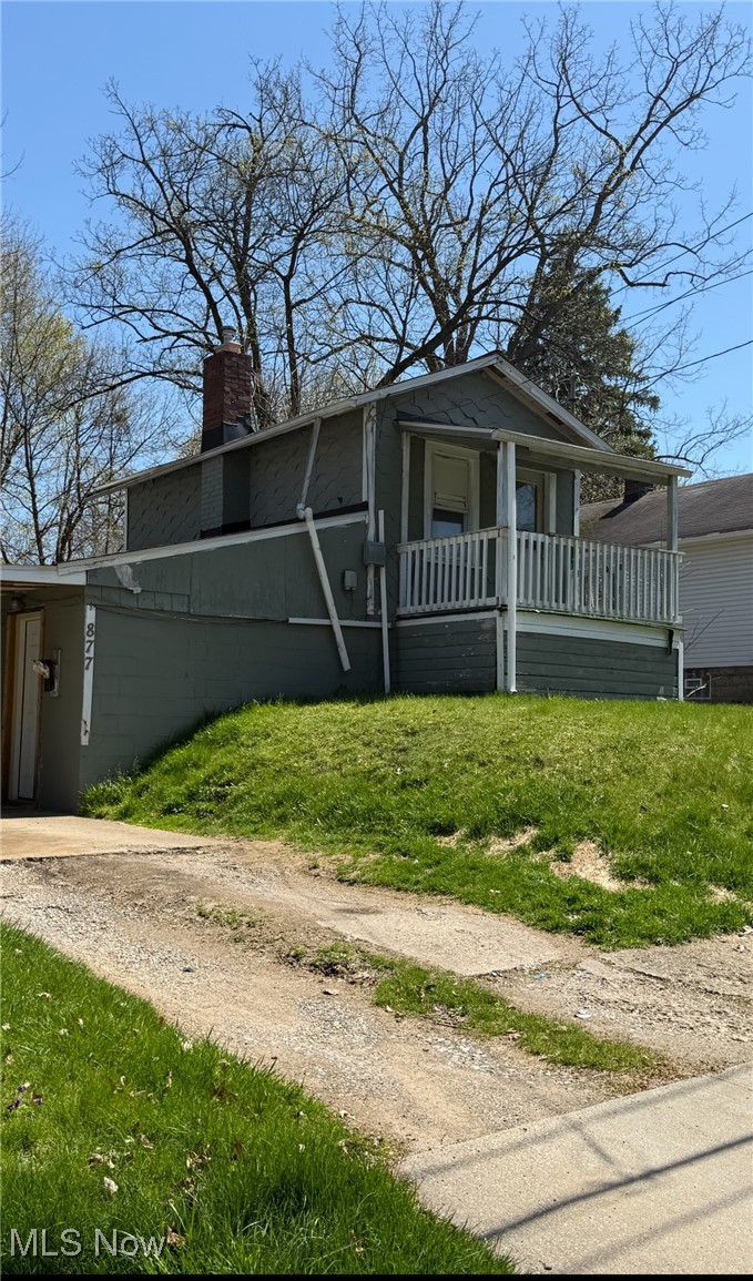 877 Garfield Street Akron, OH 44310 - Photo 1 of 16 View of front facade featuring a chimney, a front lawn, and dirt driveway
