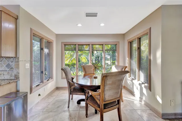a bathroom with a granite countertop sink a toilet a mirror and shower curtain