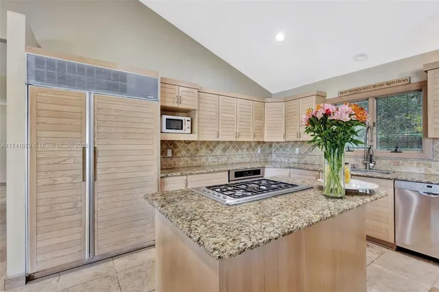 a spacious bedroom with a bed and a chandelier