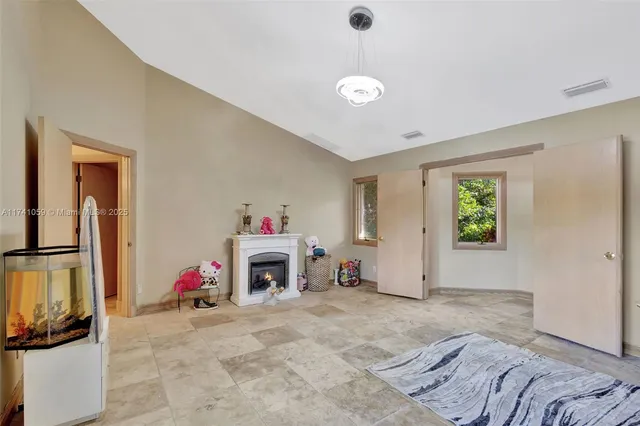 a view of a patio with table and chairs potted plants with wooden fence