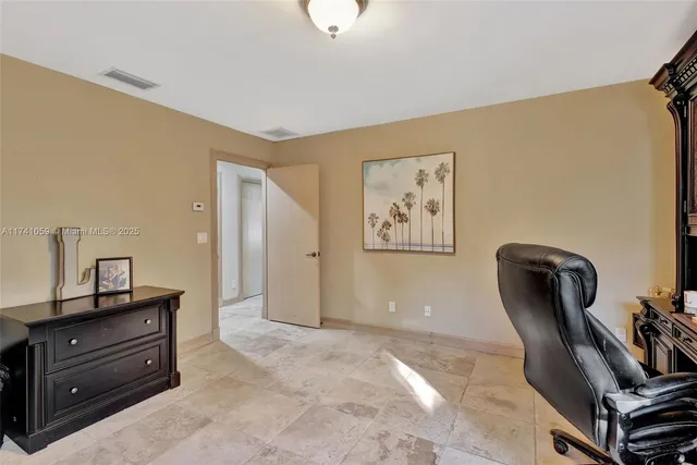 an aerial view of residential houses with outdoor space and parking