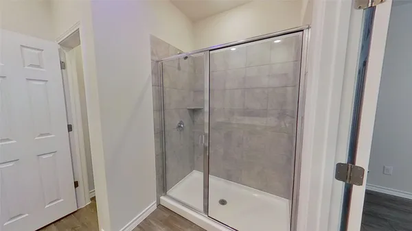 a bathroom with a glass shower door