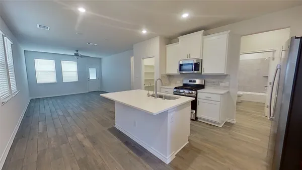 a kitchen with a sink stove and refrigerator