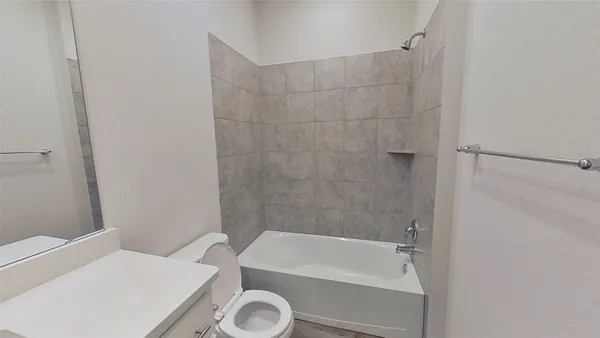 a bathroom with a tub a sink and a shower