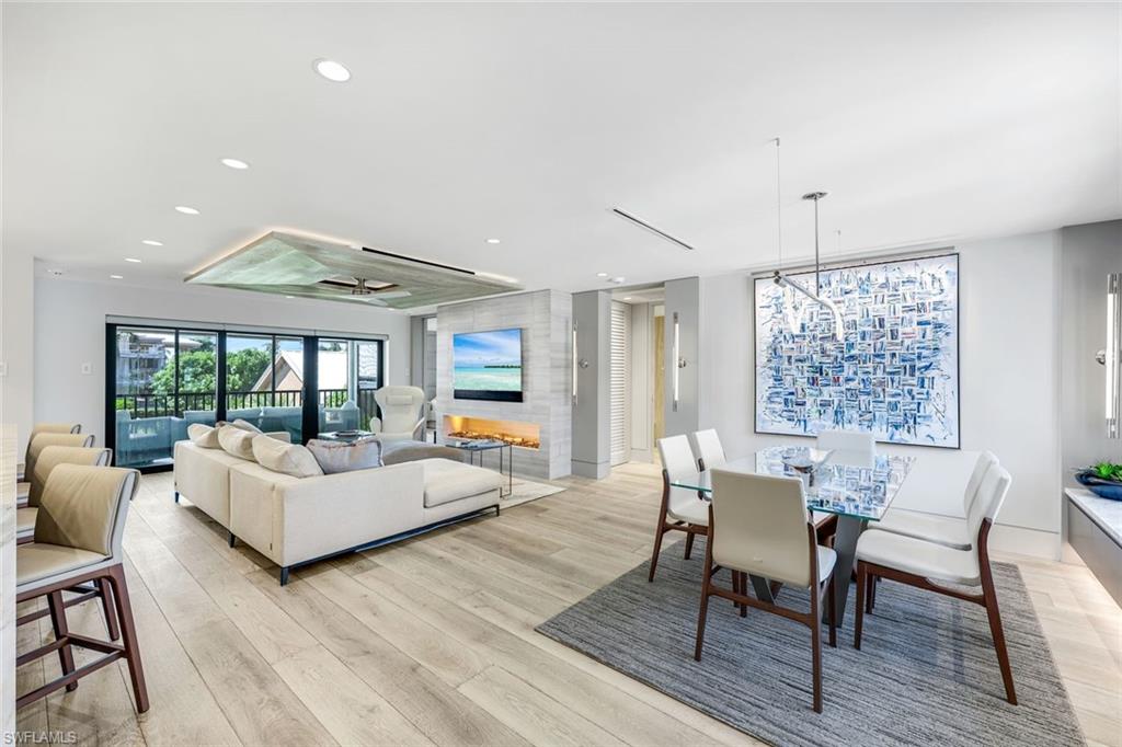 295 5th Avenue South Naples, FL 34102 - Photo 12 of 29 a living room with furniture and a large window