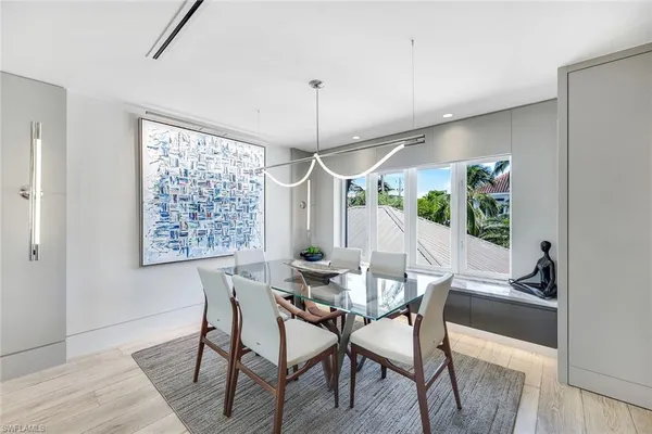 a view of a dining room with furniture window and wooden floor