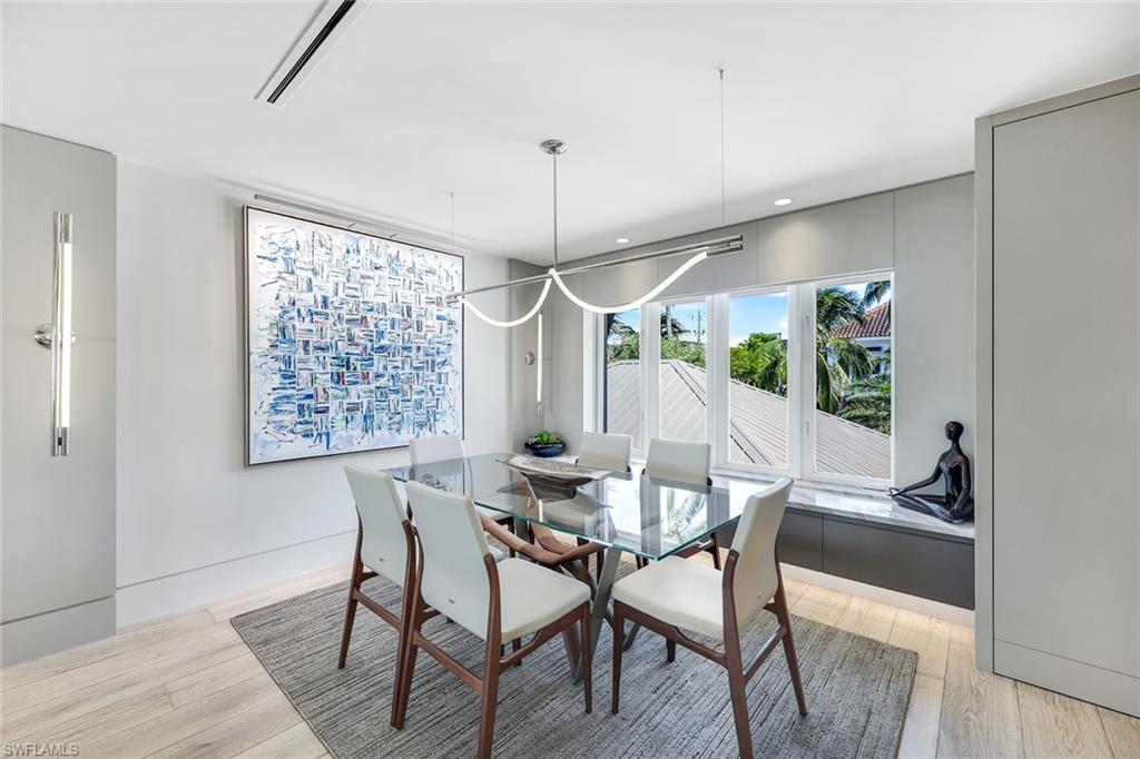 295 5th Avenue South Naples, FL 34102 - Photo 13 of 29 a view of a dining room with furniture window and wooden floor