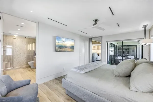 a view of a bedroom with a large window and couch