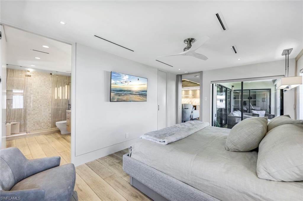 295 5th Avenue South Naples, FL 34102 - Photo 15 of 29 a view of a bedroom with a large window and couch