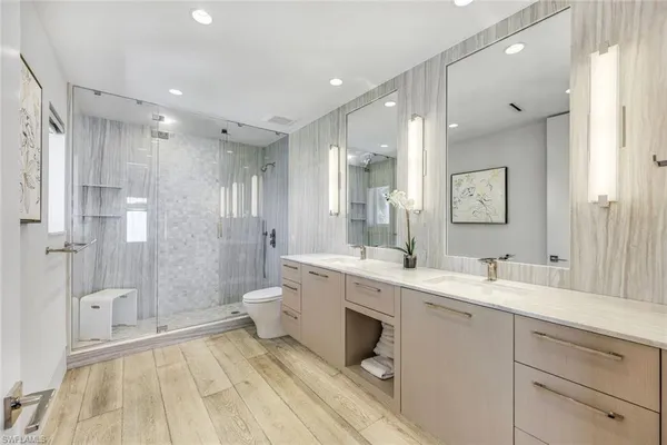 a spacious bathroom with a double vanity sink mirror double and shower
